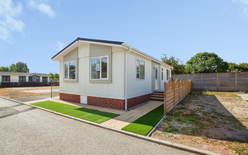 Single story home with white walls and 3 large visible windows